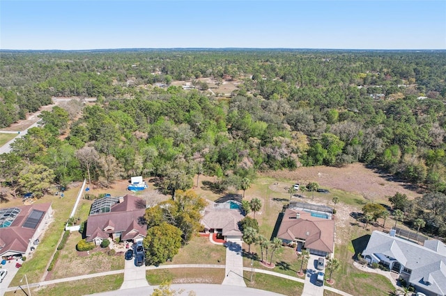 drone / aerial view with a forest view and a residential view