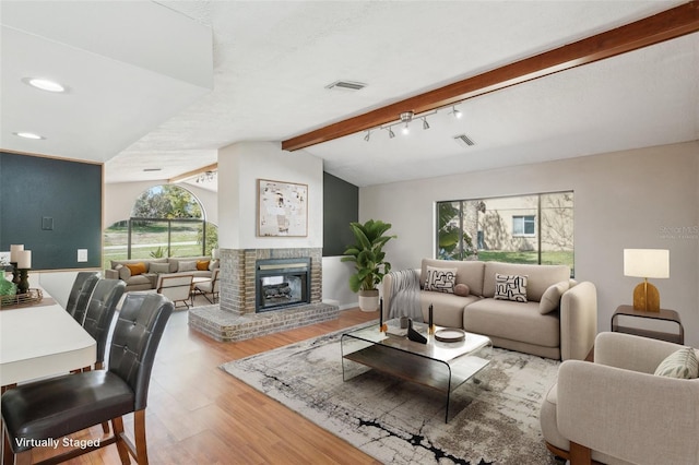 14048 Bruni Dr, Spring Hill, FL 34609 - living room featuring wood finished floors, a fireplace, and recessed lighting