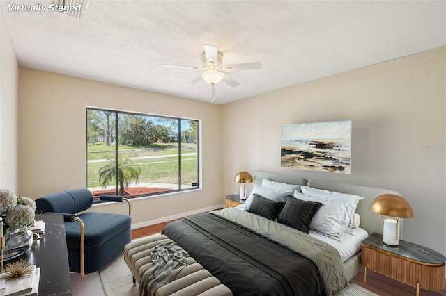 14048 Bruni Dr, Spring Hill, FL 34609 - bedroom featuring wood finished floors and a ceiling fan