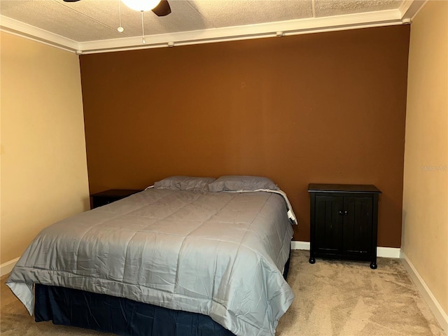 bedroom with a ceiling fan, carpet, baseboards, and ornamental molding