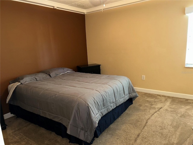 bedroom featuring baseboards and carpet floors