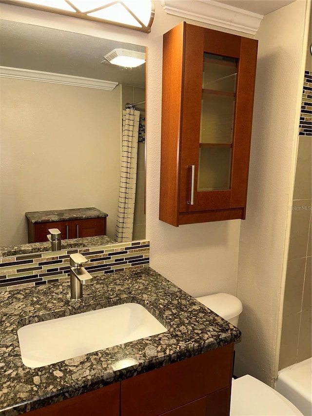 bathroom featuring toilet, curtained shower, vanity, and crown molding