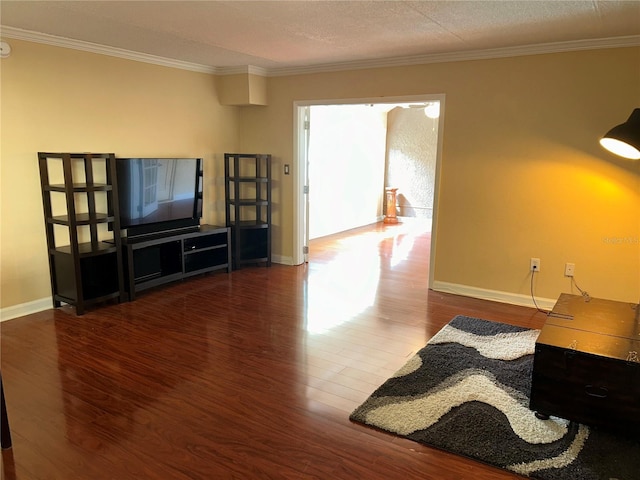 living area featuring ornamental molding, baseboards, and wood finished floors