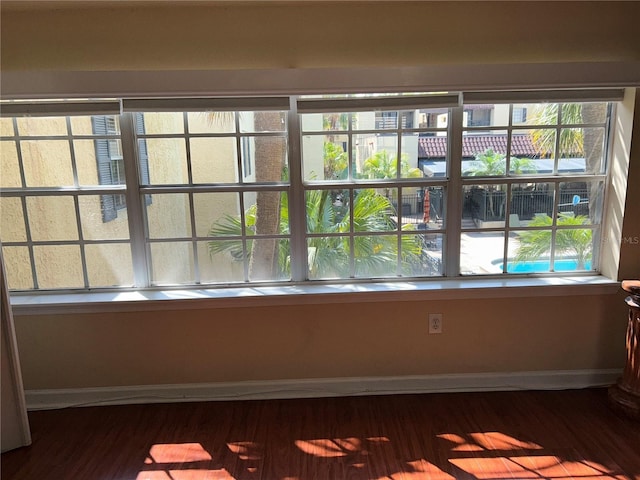 interior space featuring baseboards and wood finished floors