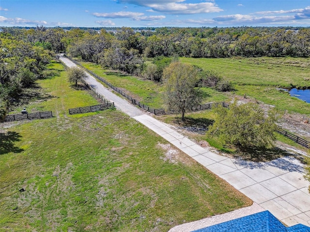 aerial view featuring a rural view and a wooded view