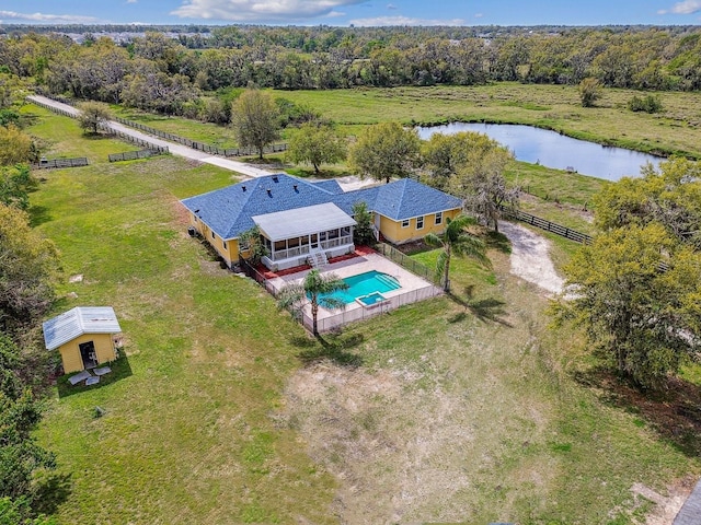 drone / aerial view with a water view and a wooded view