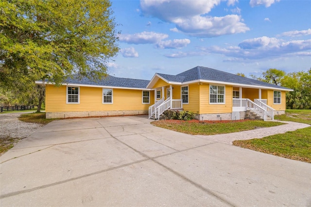 ranch-style home featuring fence, roof with shingles, and crawl space