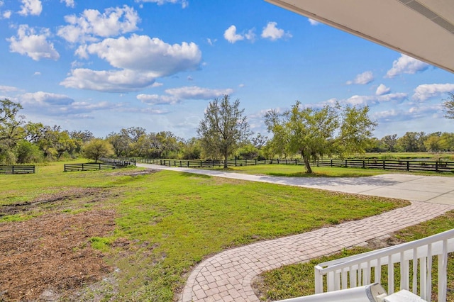 view of yard featuring a rural view and fence