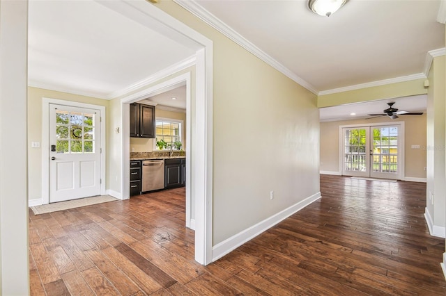 hall featuring dark wood-style floors, baseboards, and ornamental molding