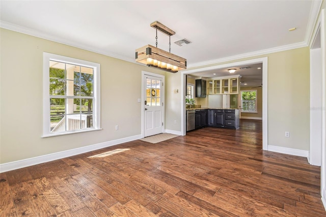 kitchen featuring visible vents, dark wood-style flooring, and ornamental molding