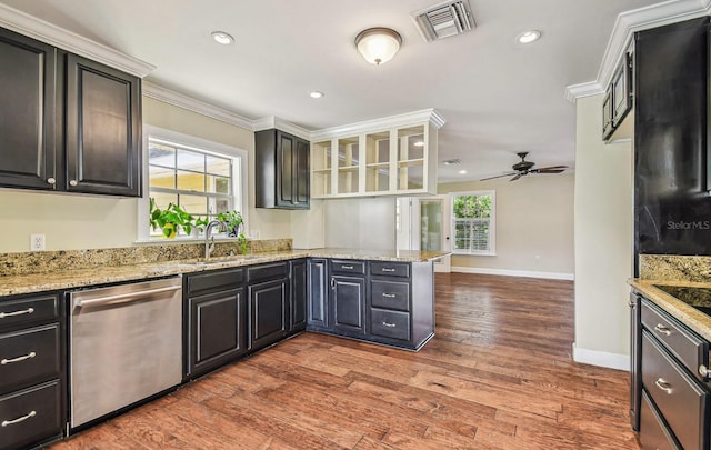 kitchen featuring wood finished floors, visible vents, ornamental molding, a sink, and stainless steel dishwasher