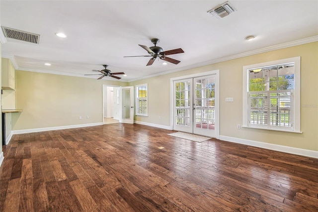 unfurnished living room with visible vents, crown molding, and hardwood / wood-style flooring