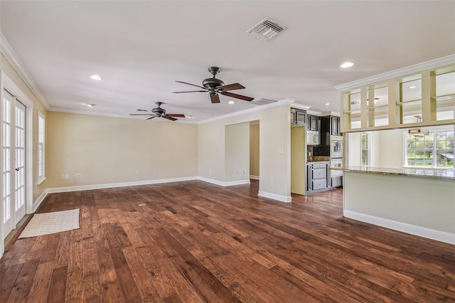 unfurnished living room featuring visible vents, dark wood-type flooring, baseboards, and ornamental molding