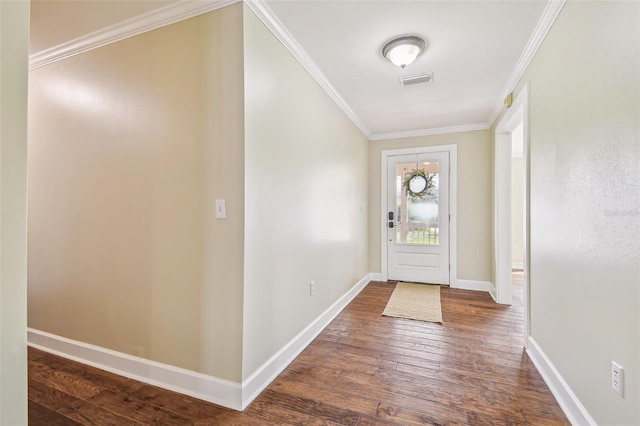 foyer entrance with visible vents, baseboards, dark wood-type flooring, and ornamental molding