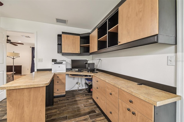 office featuring wood finish floors, visible vents, ceiling fan, and built in study area