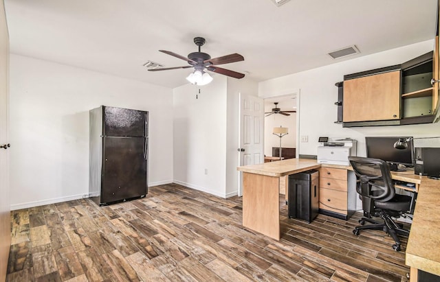 office featuring visible vents, baseboards, dark wood finished floors, and a ceiling fan