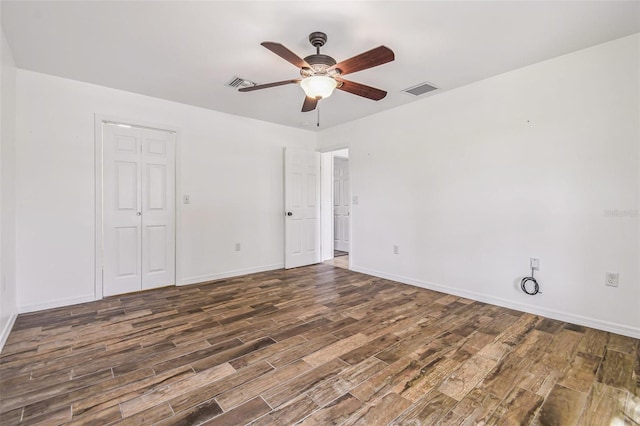 interior space featuring ceiling fan, wood finished floors, visible vents, and baseboards