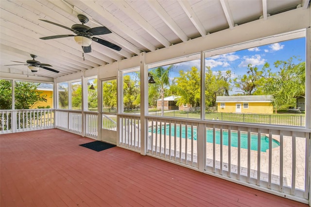 unfurnished sunroom with lofted ceiling with beams and a ceiling fan