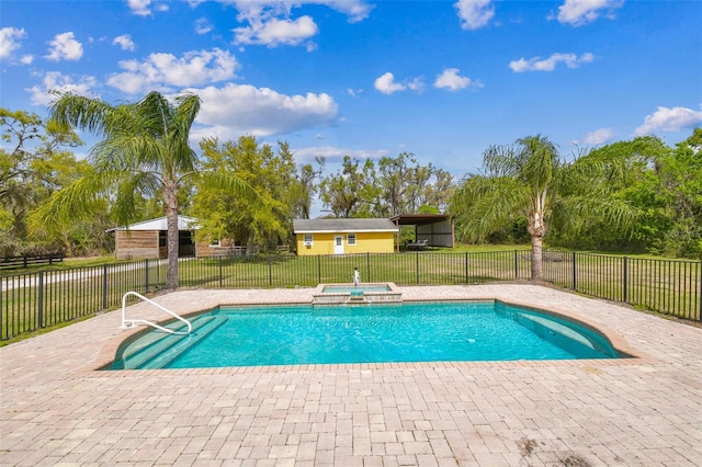 view of pool with a patio, a yard, fence, and a pool with connected hot tub