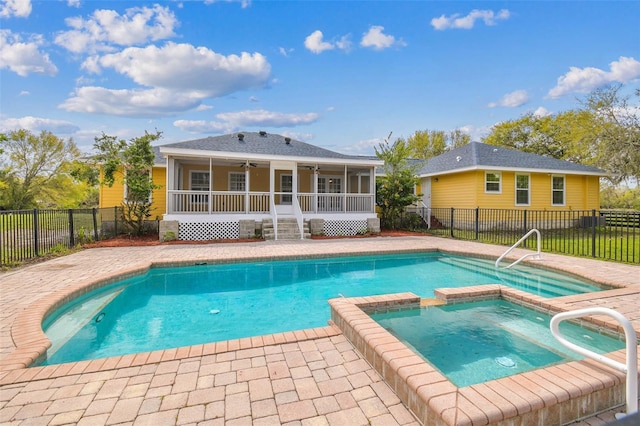 view of swimming pool featuring a ceiling fan, a pool with connected hot tub, a patio, a fenced backyard, and a sunroom