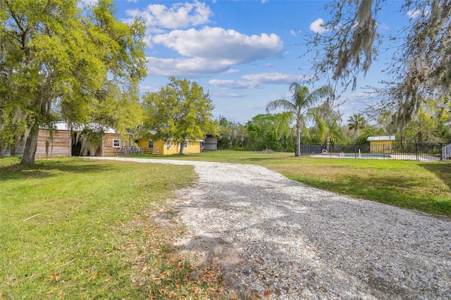 view of front of house with a front lawn and fence