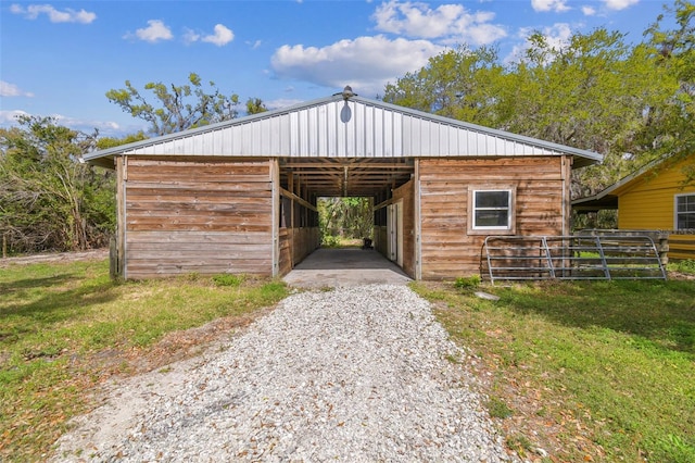 view of outbuilding with an outbuilding, driveway, and an exterior structure