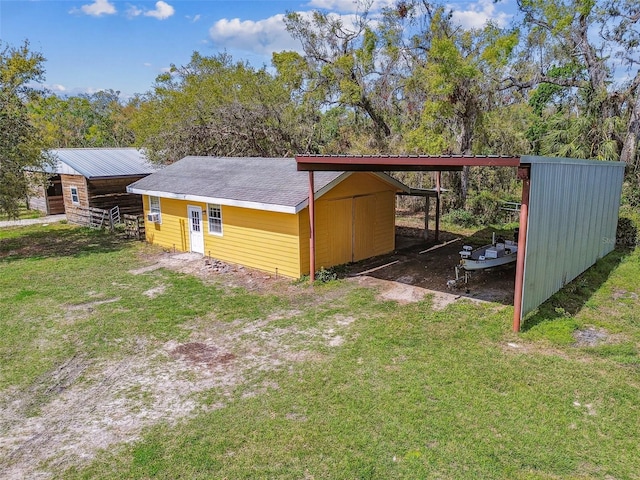 view of outdoor structure with an outbuilding and a carport