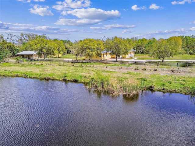 property view of water featuring fence