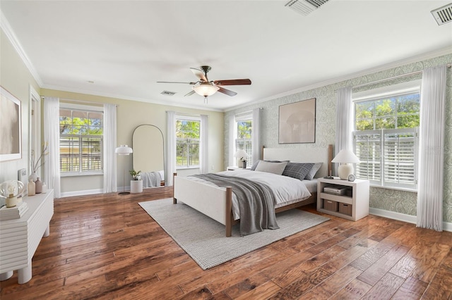 bedroom with baseboards, wood-type flooring, crown molding, and wallpapered walls