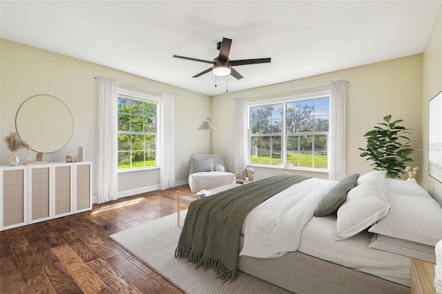 bedroom featuring ceiling fan, baseboards, and hardwood / wood-style flooring