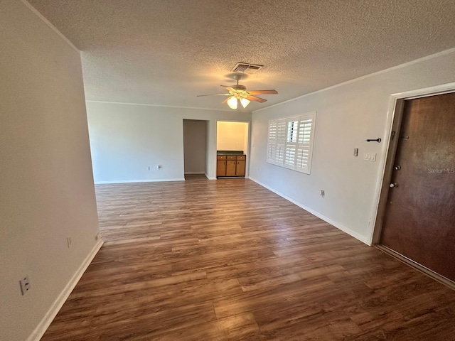 unfurnished living room with a textured ceiling, ceiling fan, wood finished floors, visible vents, and baseboards