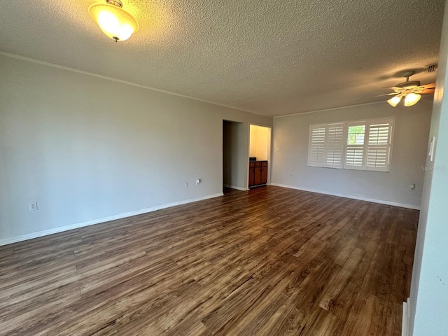 spare room with dark wood-style floors, ceiling fan, baseboards, and a textured ceiling