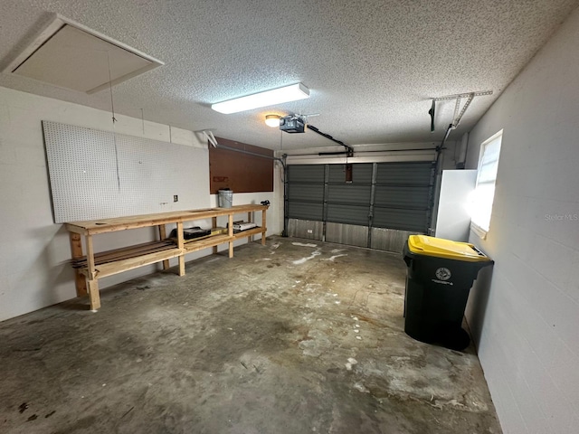 garage featuring concrete block wall and a garage door opener