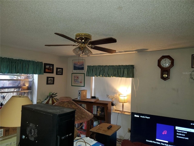 home office with a textured ceiling and ceiling fan