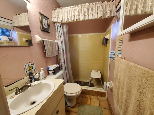 full bath featuring a textured wall, toilet, tile patterned flooring, vanity, and a shower stall