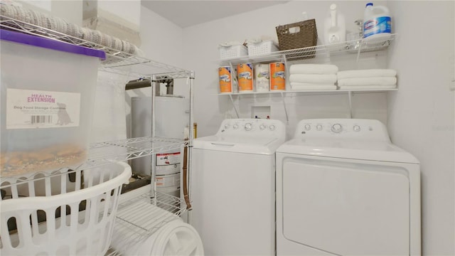 washroom with washer and dryer, laundry area, and gas water heater