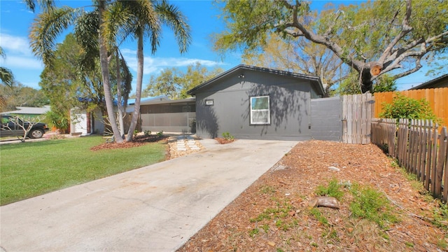 view of front of property with fence and a front lawn