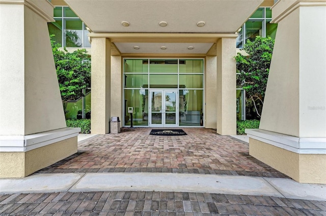 property entrance with stucco siding and french doors