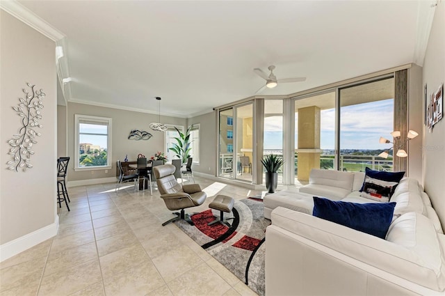 living room featuring light tile patterned floors, baseboards, a ceiling fan, ornamental molding, and floor to ceiling windows