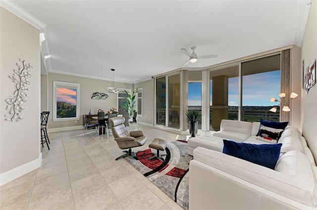 living area with light tile patterned floors, ornamental molding, a ceiling fan, a wall of windows, and baseboards