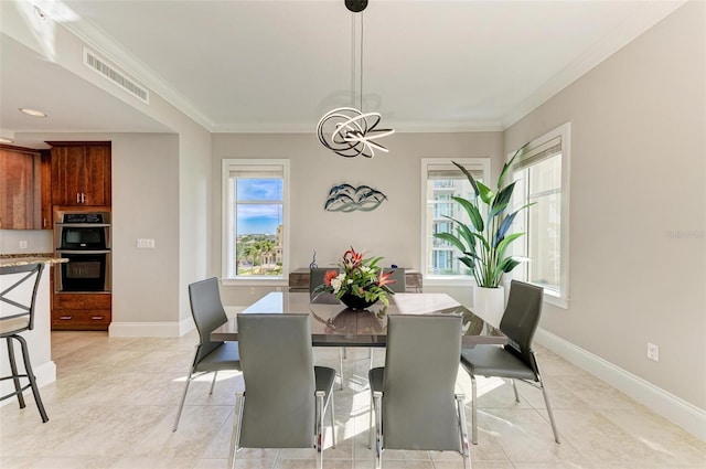 dining space with ornamental molding, visible vents, and baseboards