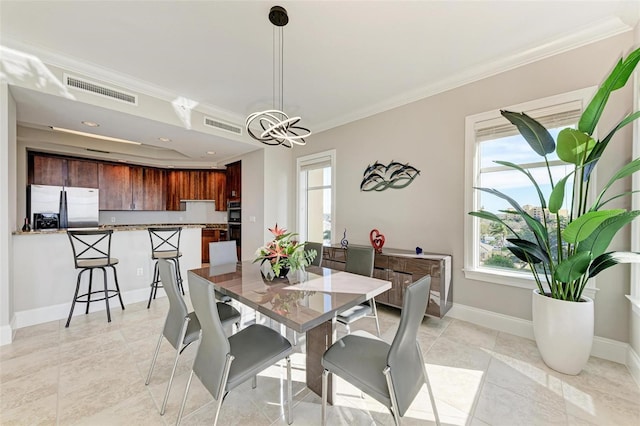 dining space with ornamental molding, visible vents, baseboards, and an inviting chandelier