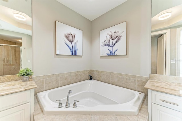 bathroom featuring a shower stall, a bath, and vanity