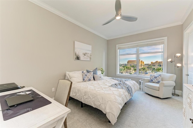 carpeted bedroom featuring ceiling fan, baseboards, and crown molding