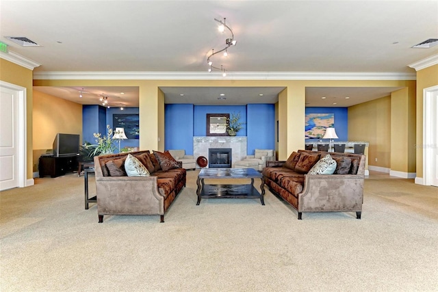 carpeted living room featuring ornamental molding, baseboards, visible vents, and a tiled fireplace