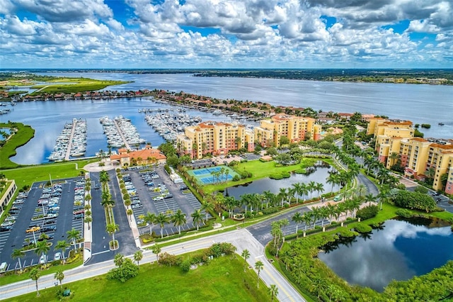 drone / aerial view featuring a view of city and a water view