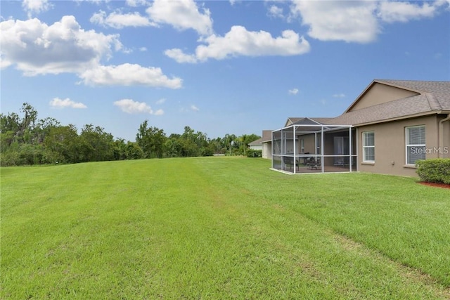 view of yard featuring glass enclosure