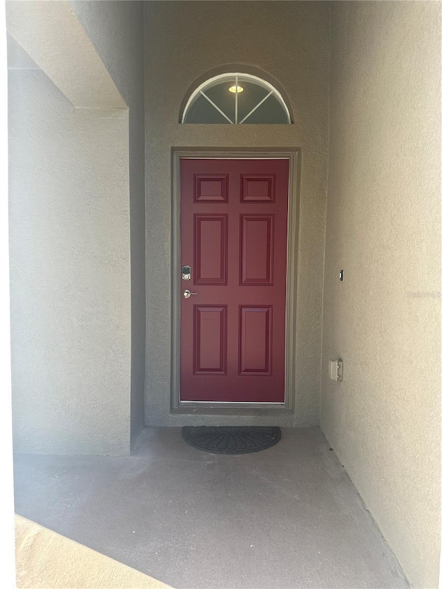 entrance to property with stucco siding