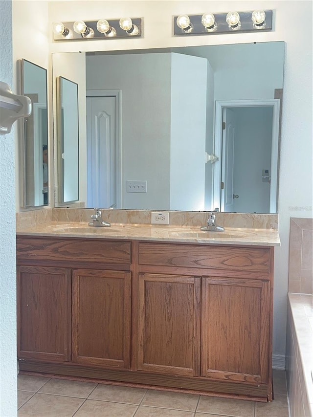 bathroom featuring tile patterned floors, a sink, and double vanity