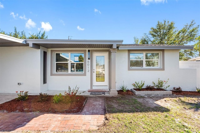 view of front of property with fence and stucco siding